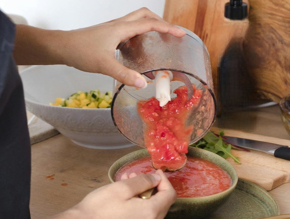 Person Pouring Red Sauce