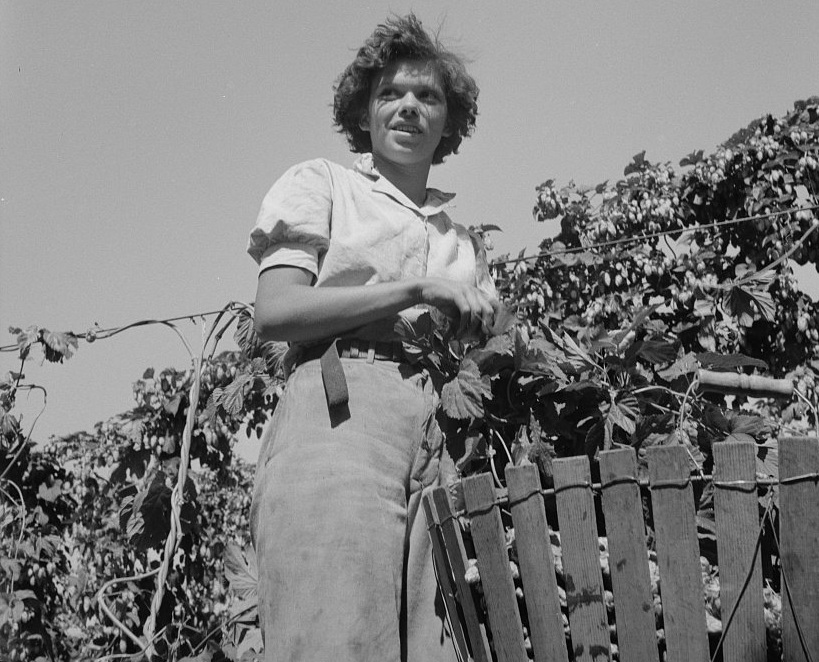 Photo of a woman standing next to a fence, Great Depression