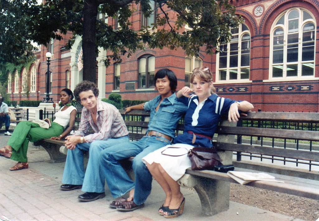 People sitting on bench outside Smithsonian, Washington, D.C., 1977