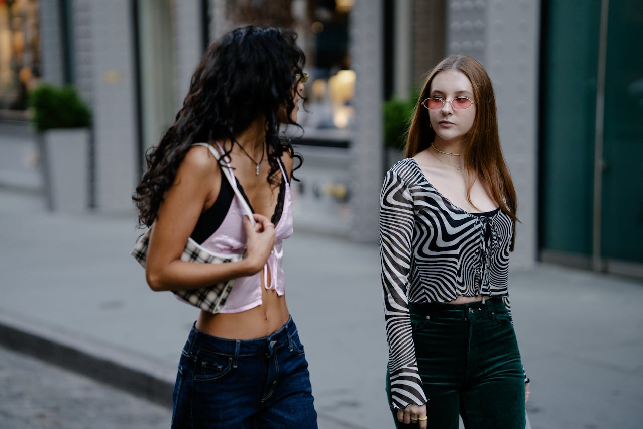 Two Teenage Girls in Trendy Clothing Walking in City