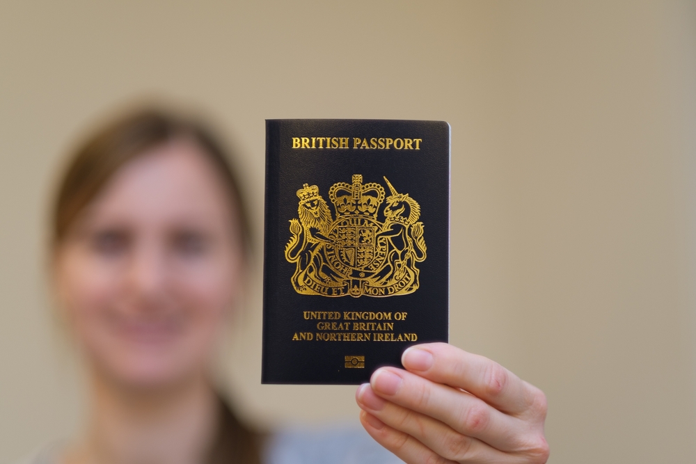 New British Passport hold in hand of young girl