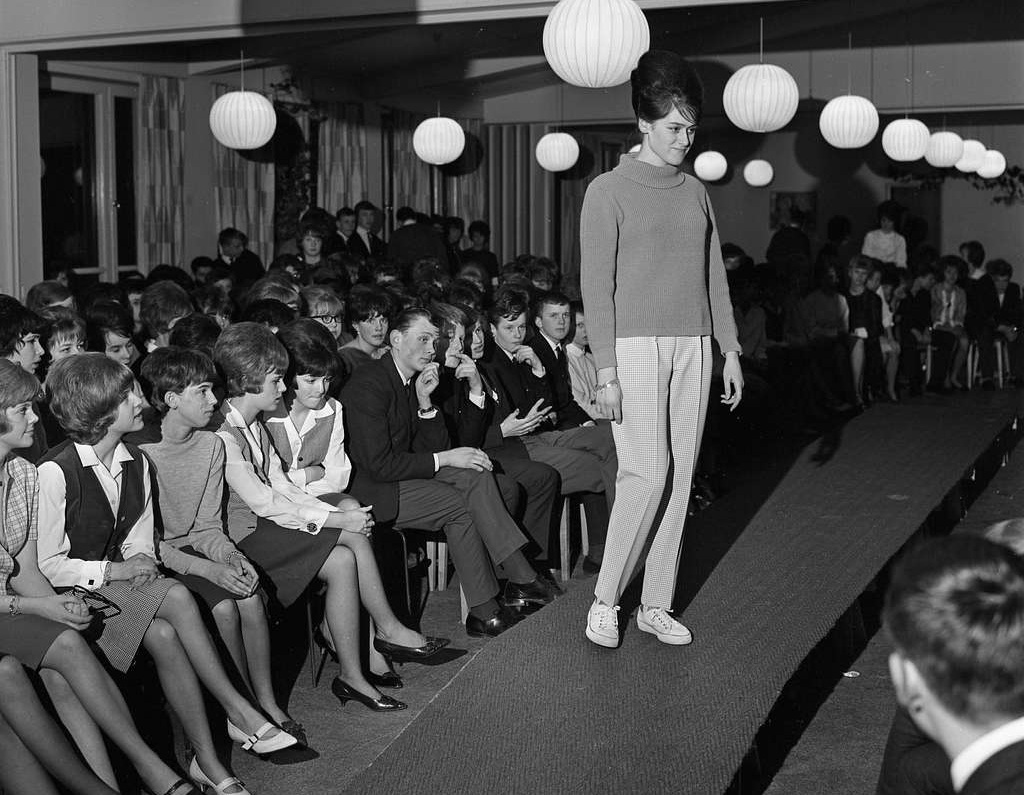 Young woman shows off polo jumper and checked trousers - 1963