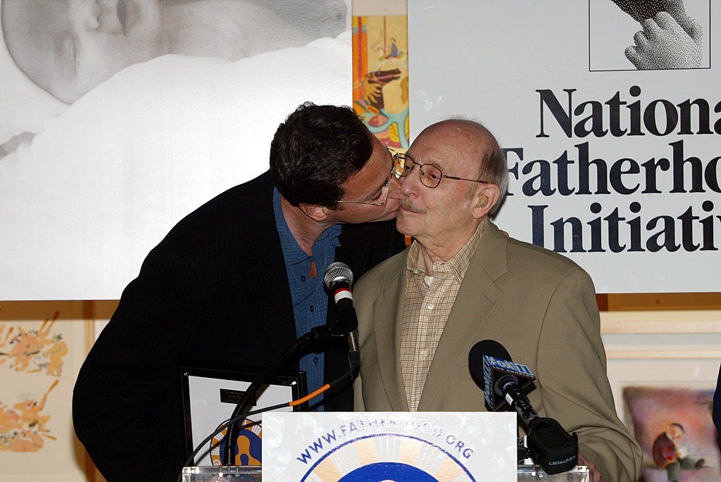 Comedian/actor Bob Saget kisses his dad