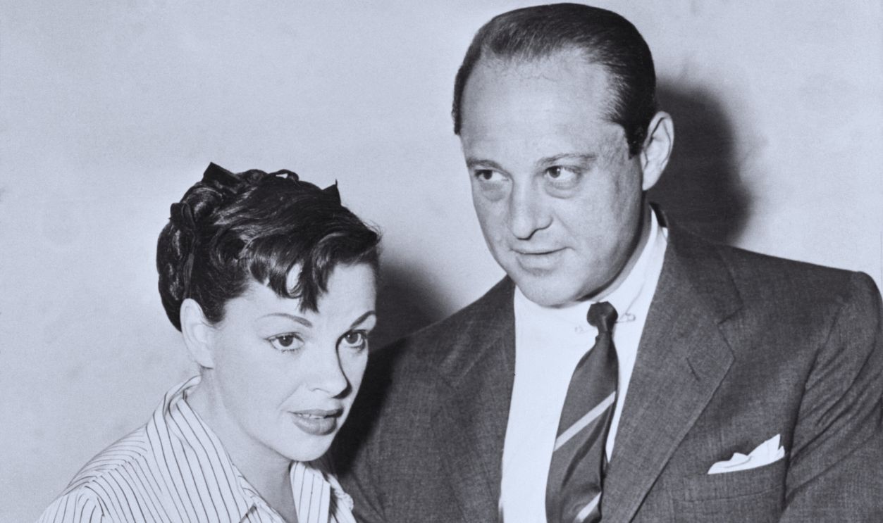 Gettyimages - 514977862, Judy Garland and Sid Luft Attending Court Hearing (Original Caption) Judy Garland and her manager and boyfriend, Sid Luft, don't look too ill at ease, as they are pictured in Los Angeles Superior Court on Thursday, minutes after an order for Miss Garland's arrest was issued by Judge Louis Burke. She was to testify as a witness in a suit brought by Luft's former wife, actress Lynn Bari.