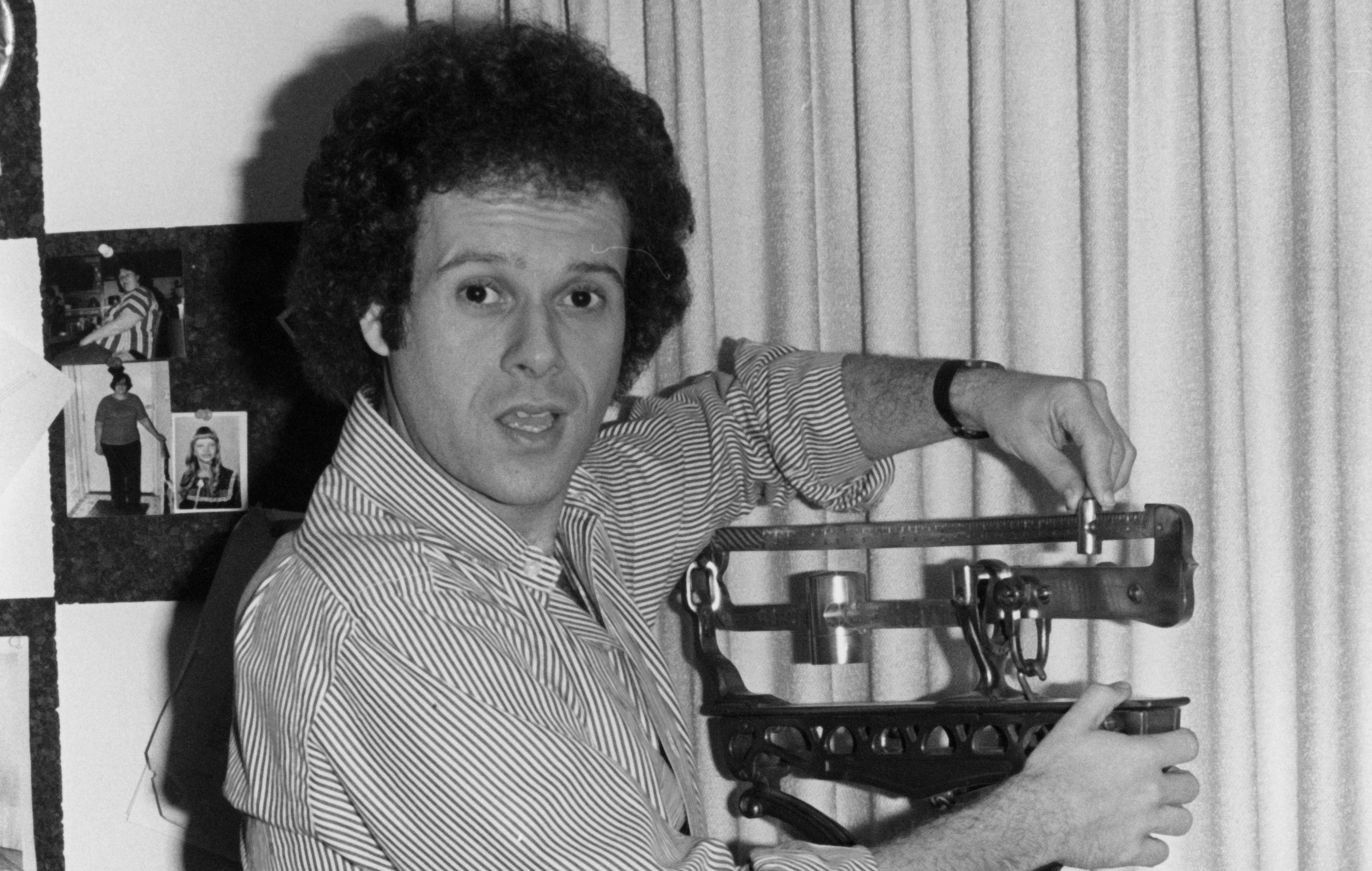 Fitness guru Richard Simmons poses for a portrait session while weighing himself on a scale