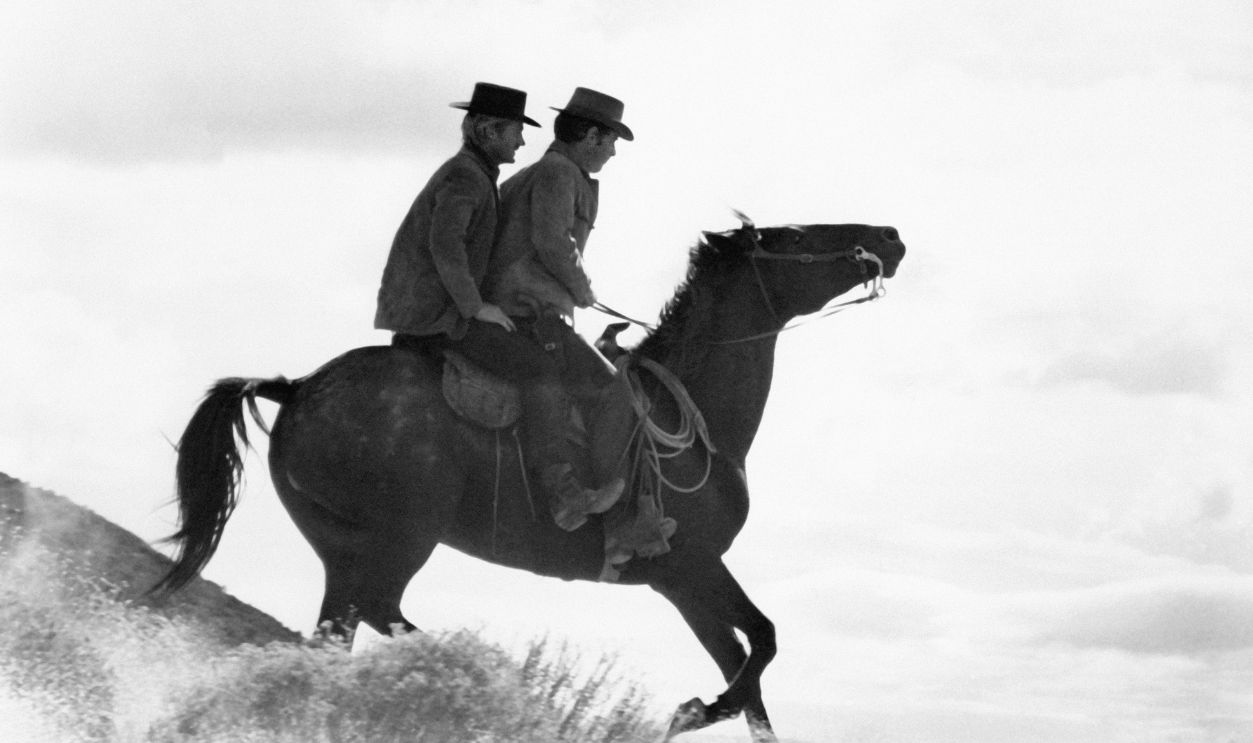 Butch Cassidy Butch Cassidy & Sundance Kid iconic image of Paul Newman and Robert Redford in profile as they both ride horse escaping capture in a scene from the classic 1969 George Roy Hill western. 