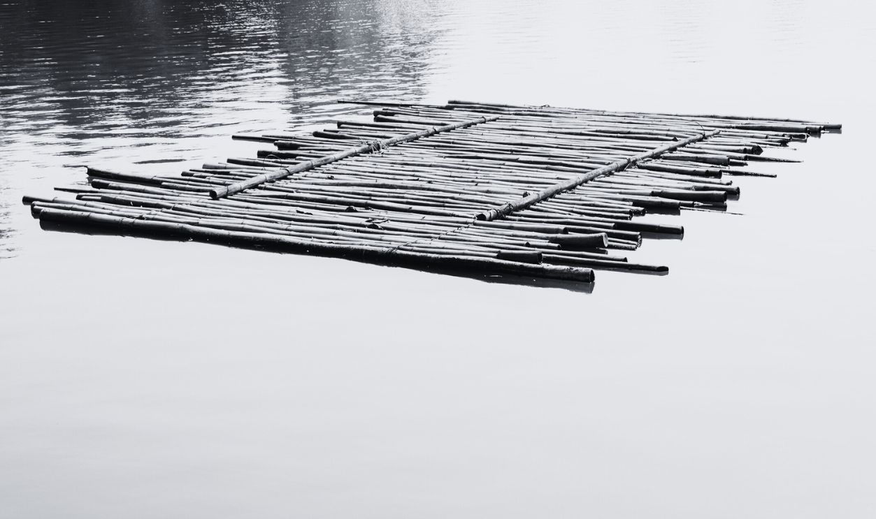 Old bamboo raft - stock photo Old bamboo raft is floating on the lake in the morning.