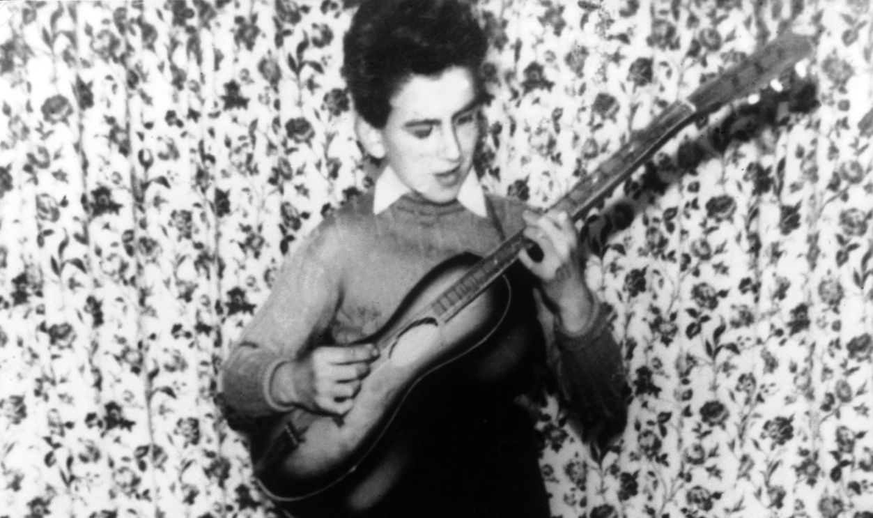 George Harrison At The Age Of Twelve, 1955 UNITED KINGDOM - JANUARY 01: Portrait of the guitarist George HARRISON, of the English music group the BEATLES, playing the guitar at his home in Liverpool at the age of 12.