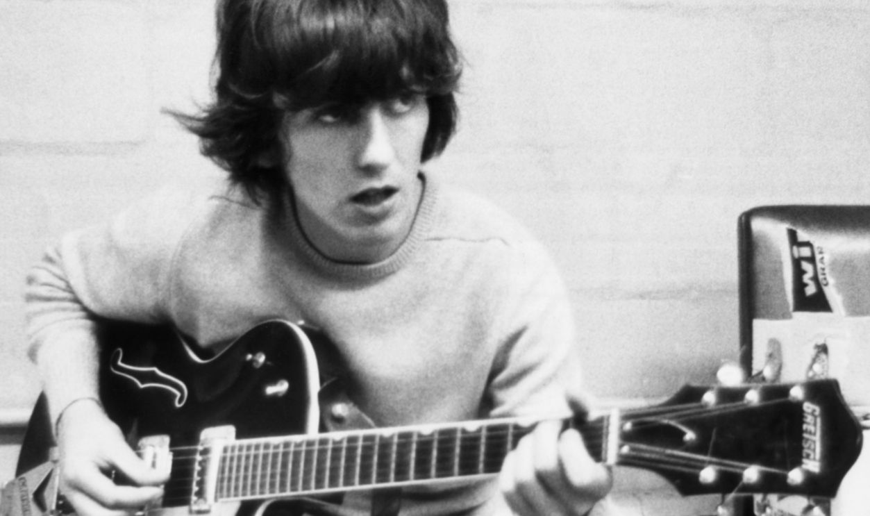 George Harrison Playing Guitar Guitarist George Harrison of The Beatles rehearsing, circa 1967.