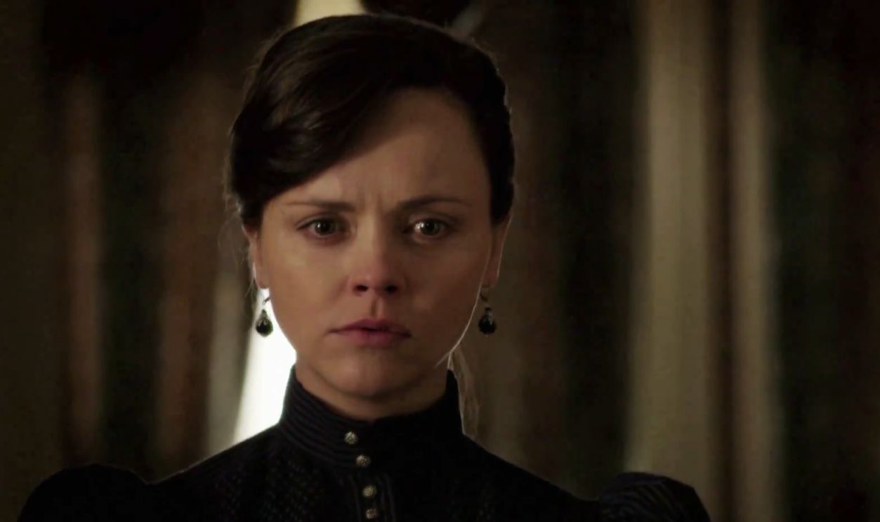 Lady in black dress with an odd expression on her face