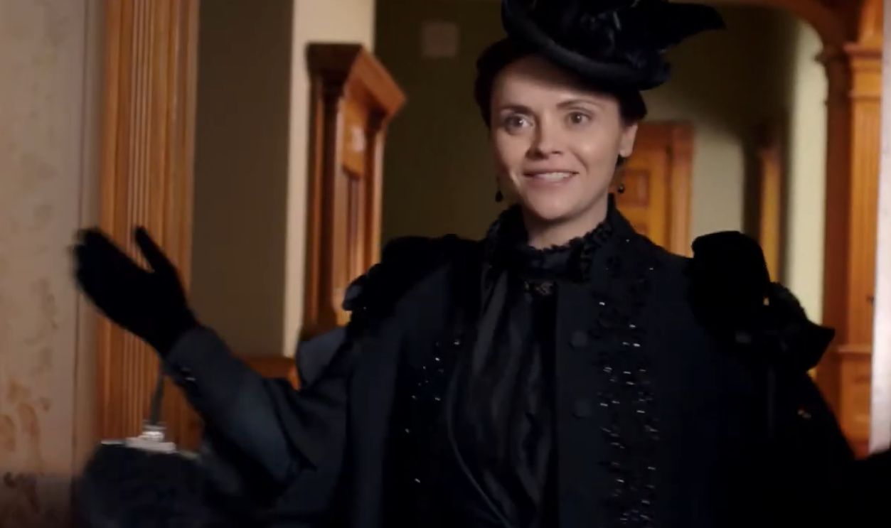 Lady wearing all black ensemble opening the door