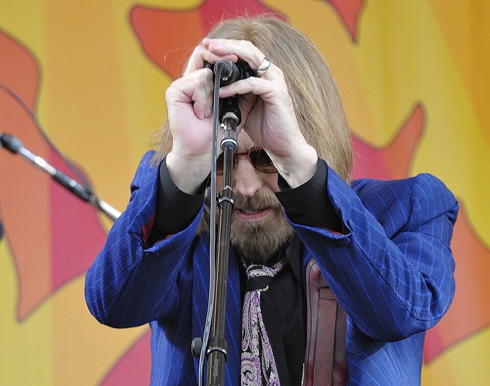 Tom Petty holding a microphone