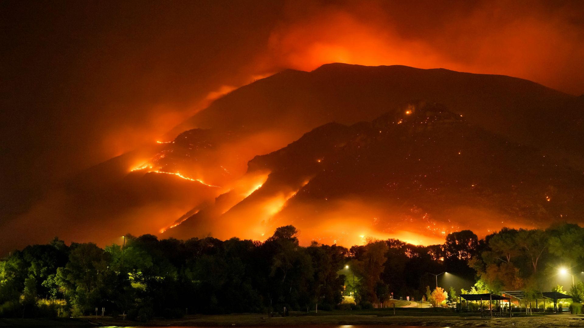 a large fire is burning in the mountains