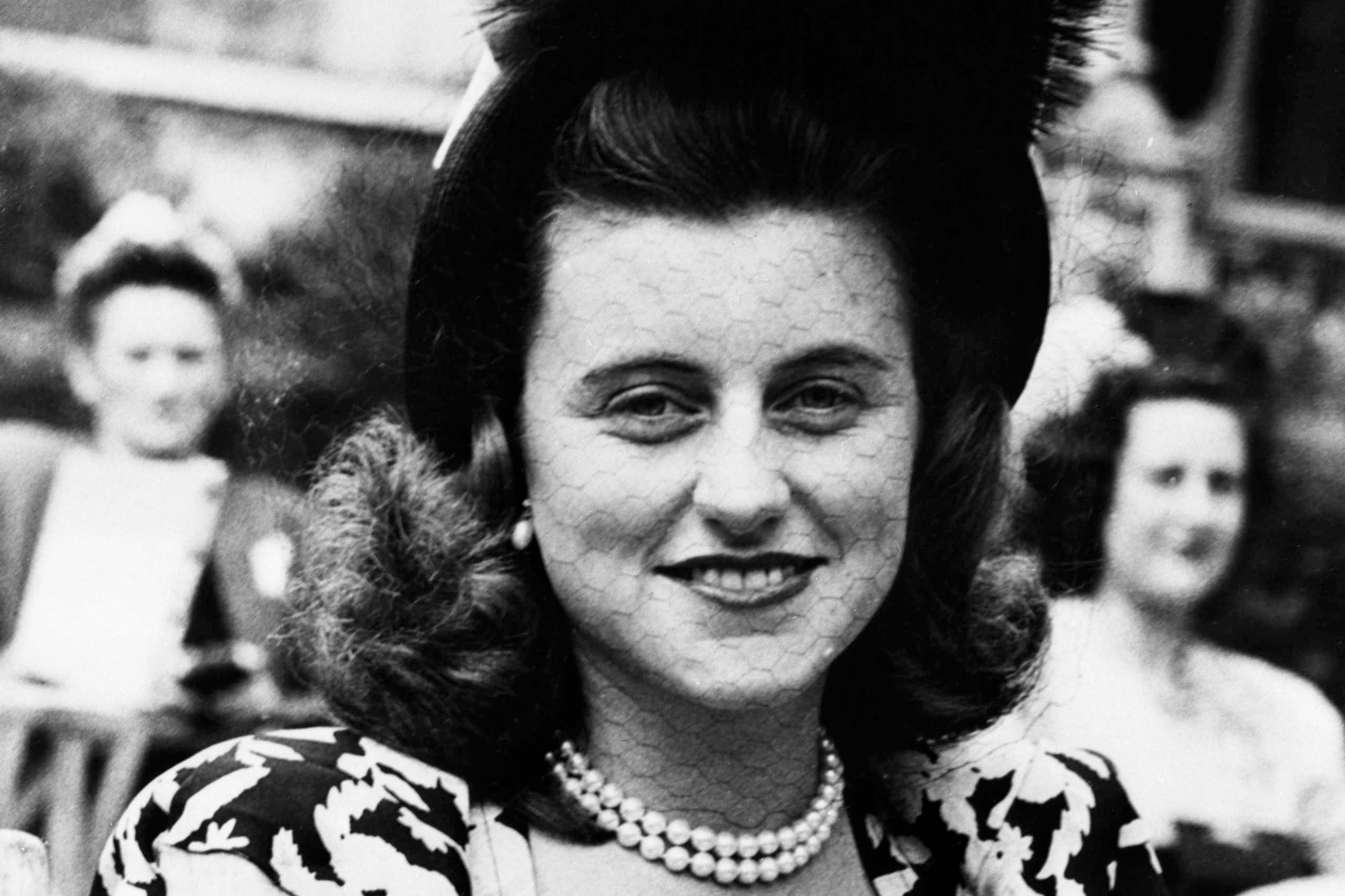 Kathleen Cavendish in patterned dress and hat