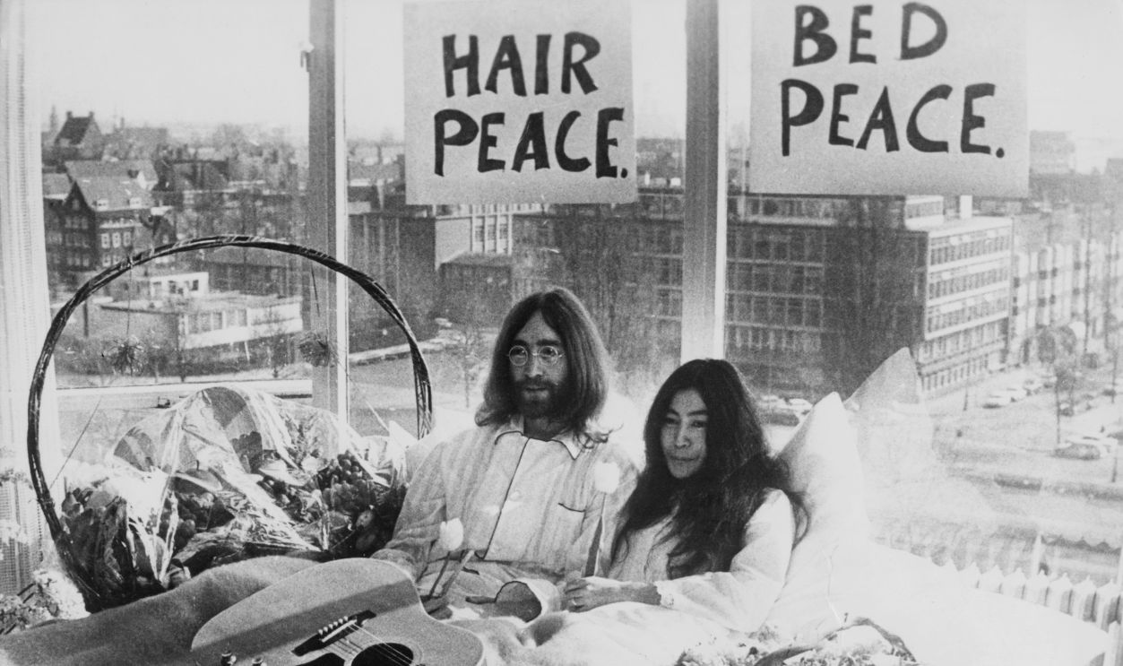 Gettyimages - 101010214, Bed-In For Peace A week after their marriage, musicians John Lennon and Yoko Ono lay in their bed in the Presidential Suite of the Hilton Hotel, Amsterdam, 25th March 1969. The couple are staging a 'bed-in for peace' and intend to stay in bed for seven days 'as a protest against war and violence in the world'.