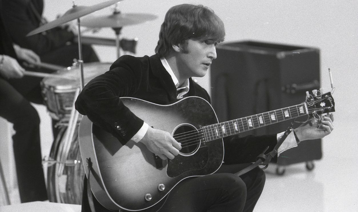 Photo of BEATLES and John LENNON UNSPECIFIED - CIRCA 1960: Photo of BEATLES and John LENNON; of the Beatles, tuning guitar (Gibson J160E acoustic) during the filming of 