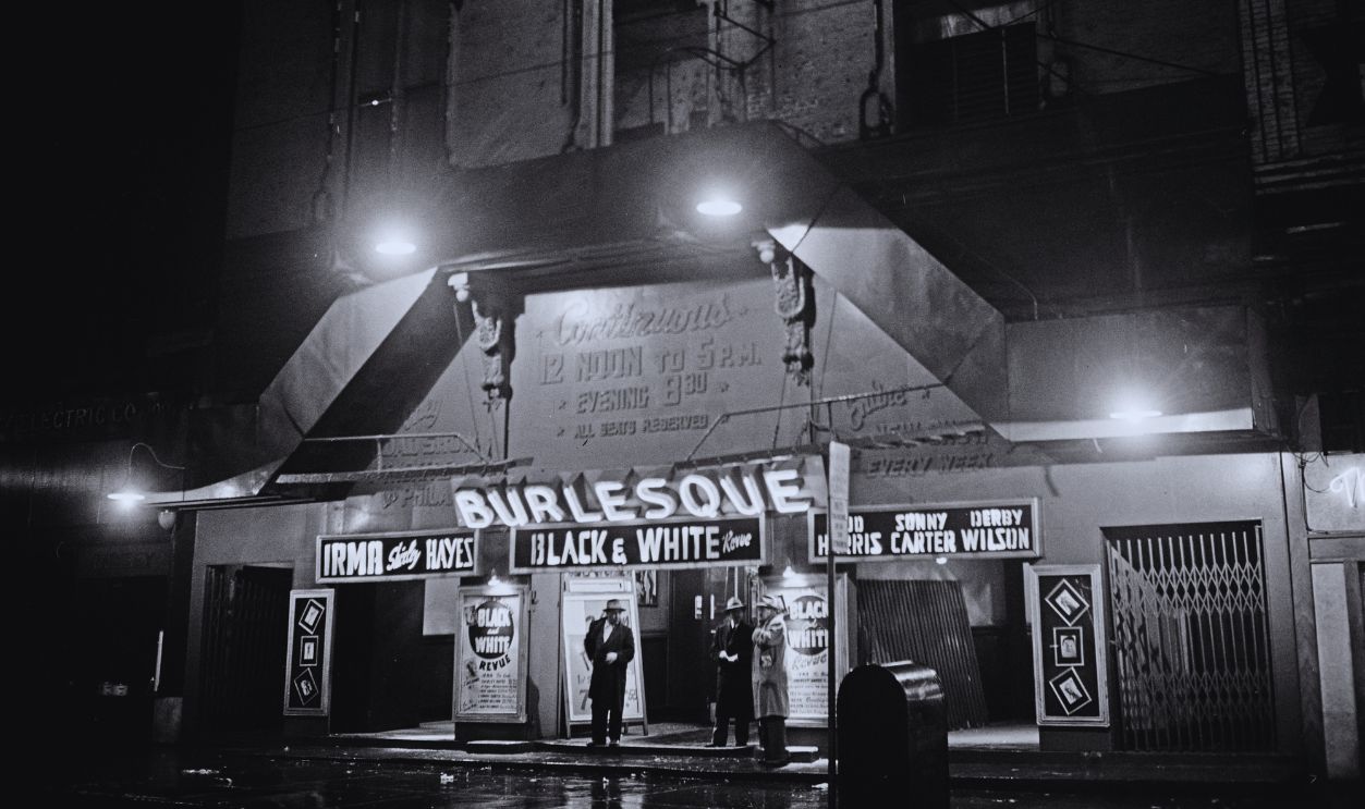 Gettyimages - 	1334734548, The Troc Burlesque Club The Troc Theatre (also known as the Trocadero Theatre), a burlesque club in the Chinatown neighbourhood of Philadelphia, Pennsylvania, circa 1950. Acts listed on the illuminated marquee are burlesque dancer Irma Shirley Hayes, comedian Bud Harris, singer Sonny Carter and tap dancer Derby Wilson, and a 'Black & White Revue'.