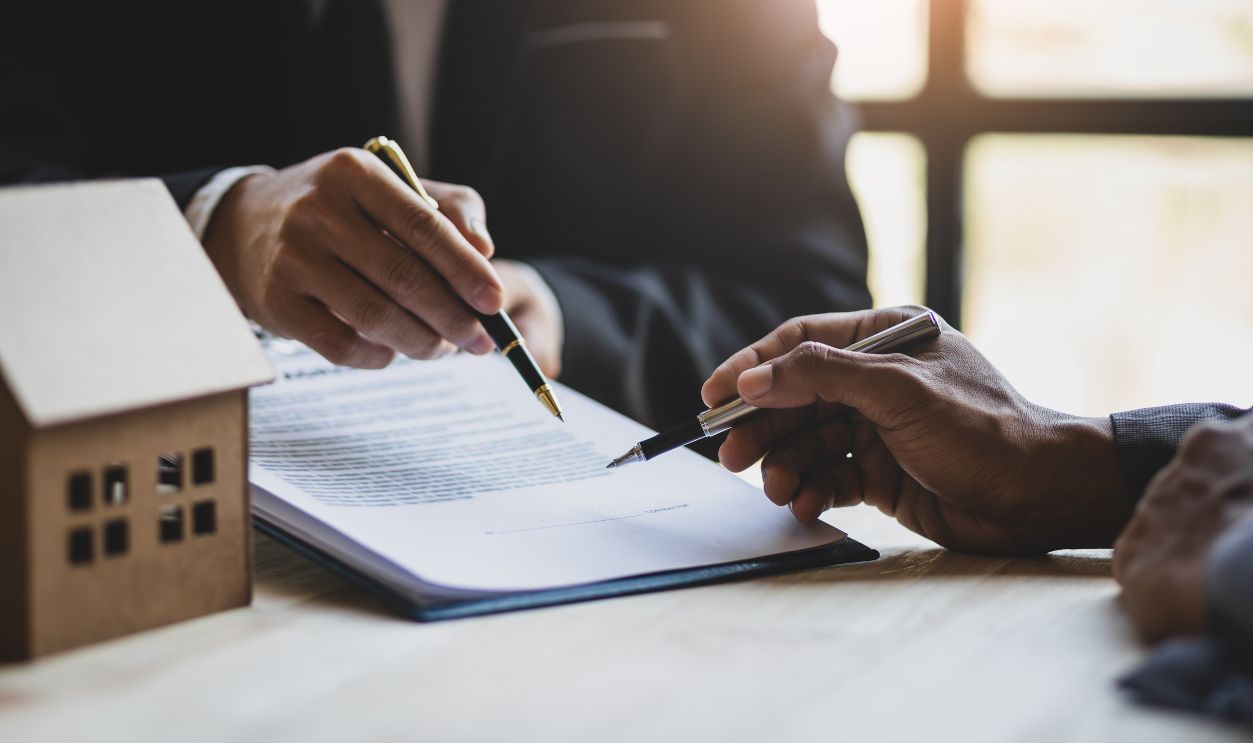 Gettyimages - 2149817687, Businessmen and real estate agents discussing documents signing a legal purchase of a house. - stock photo Businessmen and real estate agents discussing documents signing a legal purchase of a house.