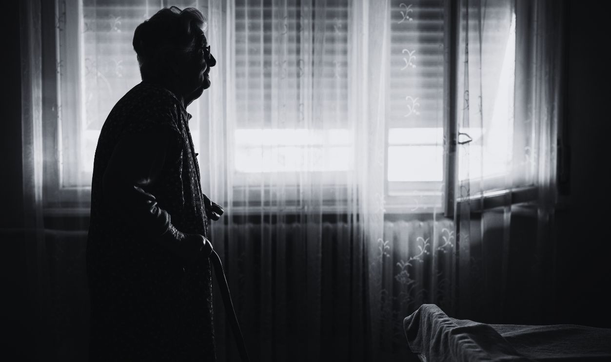 Gettyimages - 1702085863, So many memories to look back on - stock photo Senior woman with a cane looking thoughtfully out of a window at home