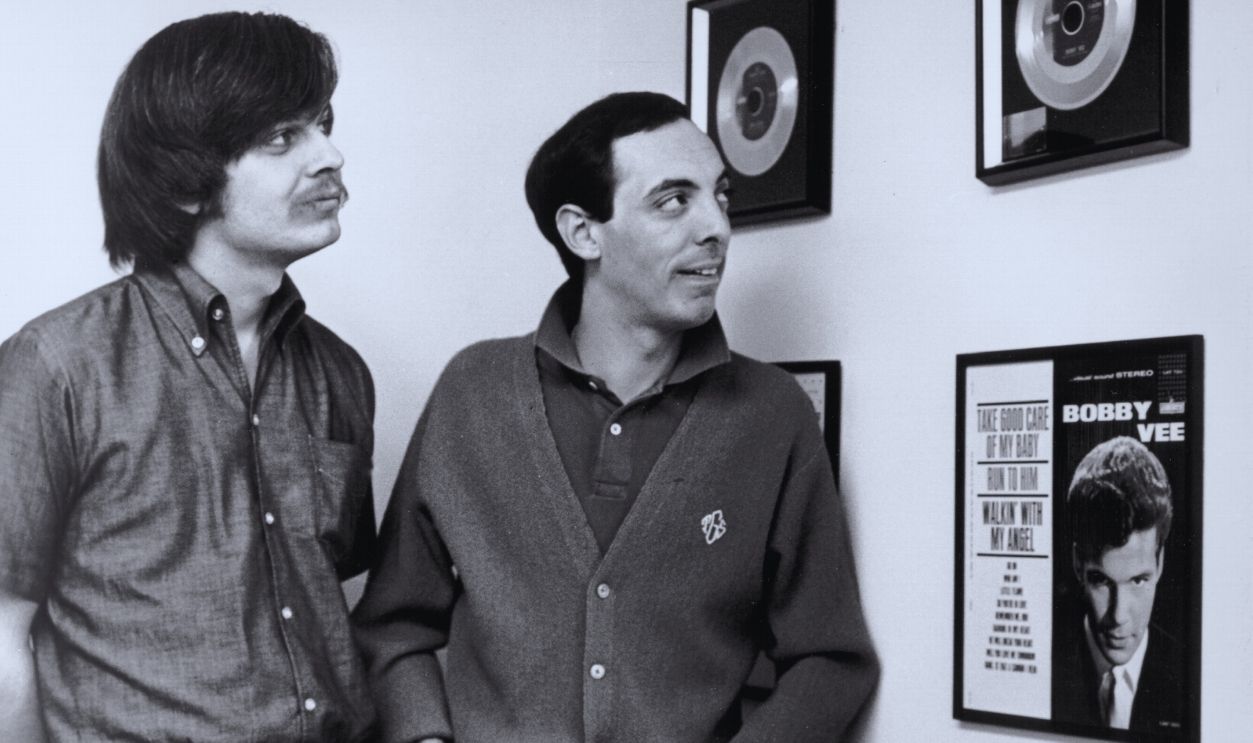 Gettyimages - 74294299, Leon Russell & His Boss LOS ANGELES - CIRCA 1968: Musician Leon Russell poses for a portrait with his boss record producer Snuff Garrett at the offices of Liberty Records as they look at a wall of framed Bobby Vee records in circa 1968 in Los Angeles, California. 