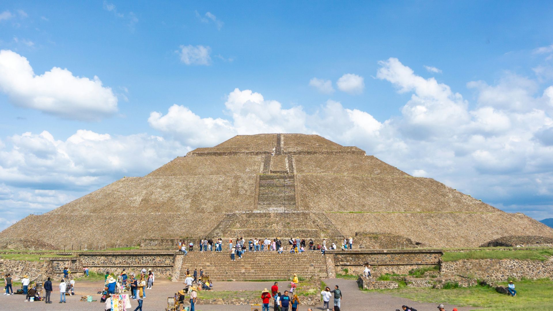 a group of people standing in front of a pyramid