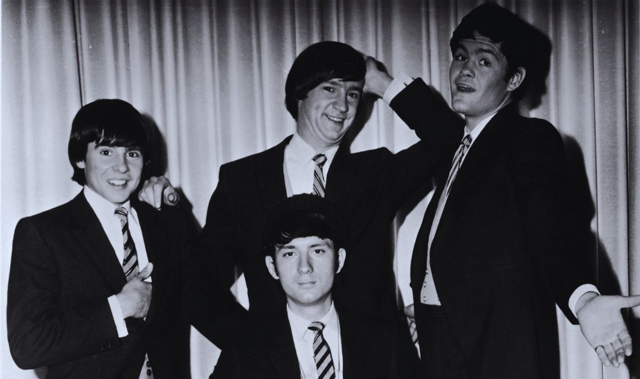 Gettyimages - 56704729, Monkees In Tail Coats Promotional portrait of popular music and television group the Monkees as they pose infront of a curtain, dressed in tail coats and pin-stripe trousers, late 1960s. From left, Davy Jones, Michael Nesmith (sitting), Peter Tork, and Mickey Dolenz.