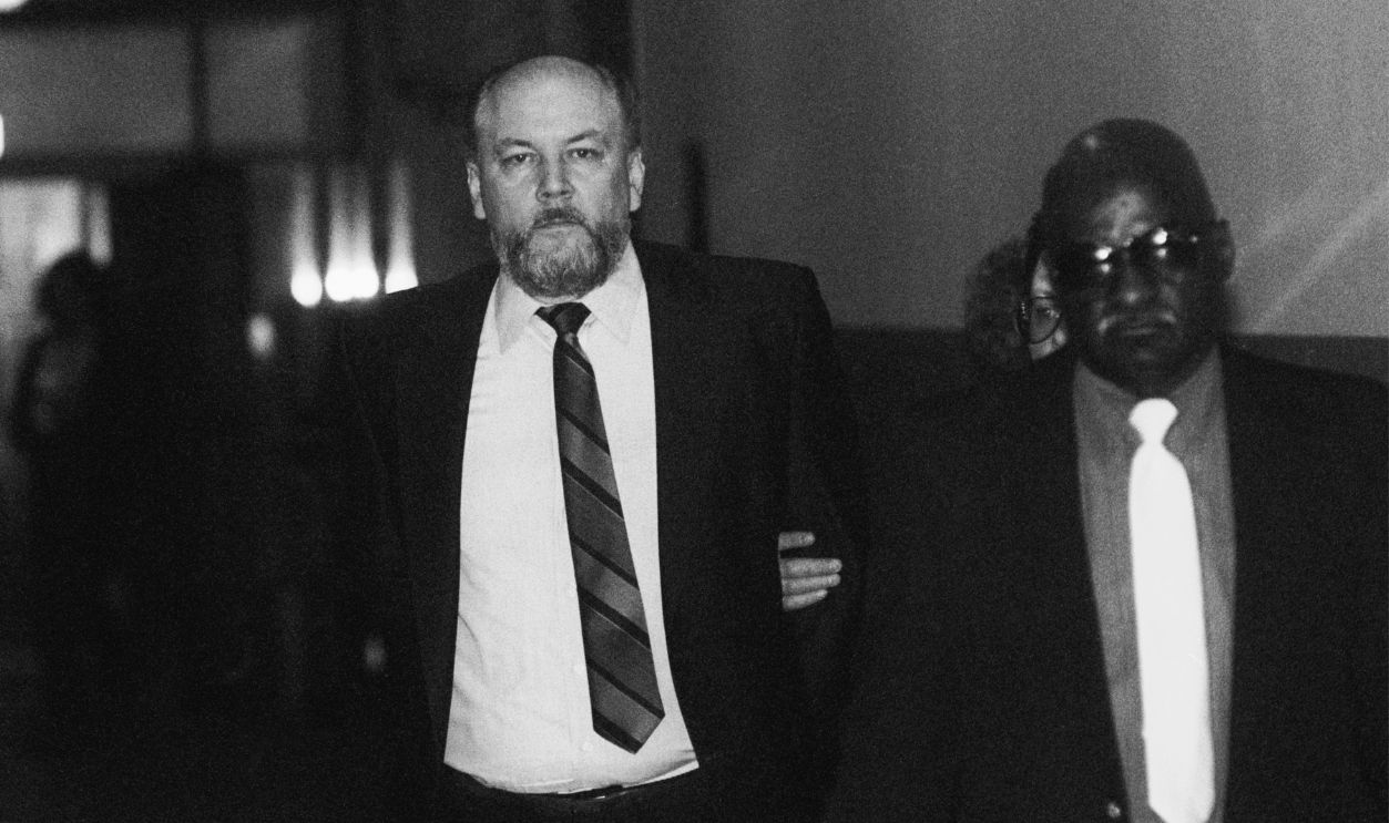 Richard Kuklinski, known as the Iceman, is led into Bergen County Court. Kuklinski, indicted for six murders, appeared in court after having kidney stones during the previous weekend.