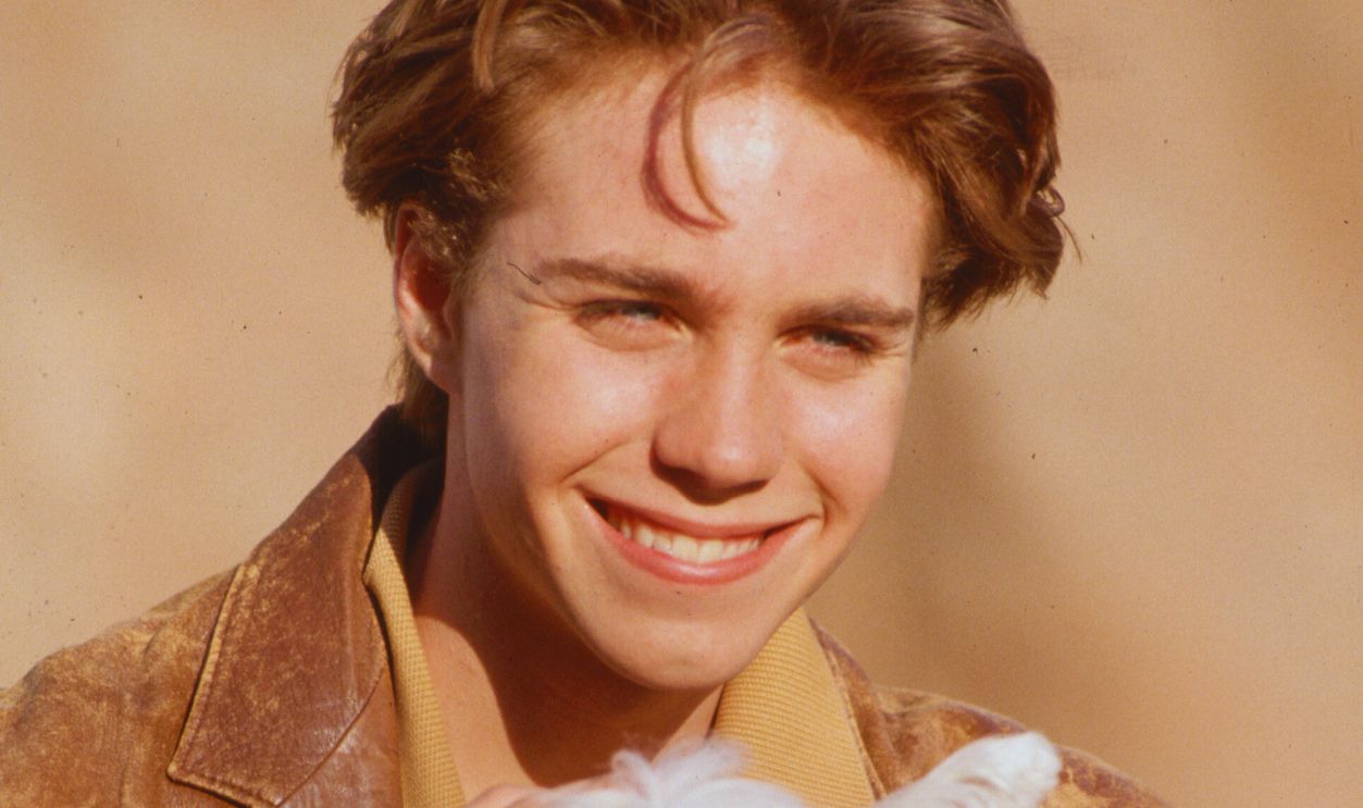 Gettyimages - 635763979, Teen Actor Holding White Dog Teen actor Jonathan Brandis hold a West Highland white terrier.