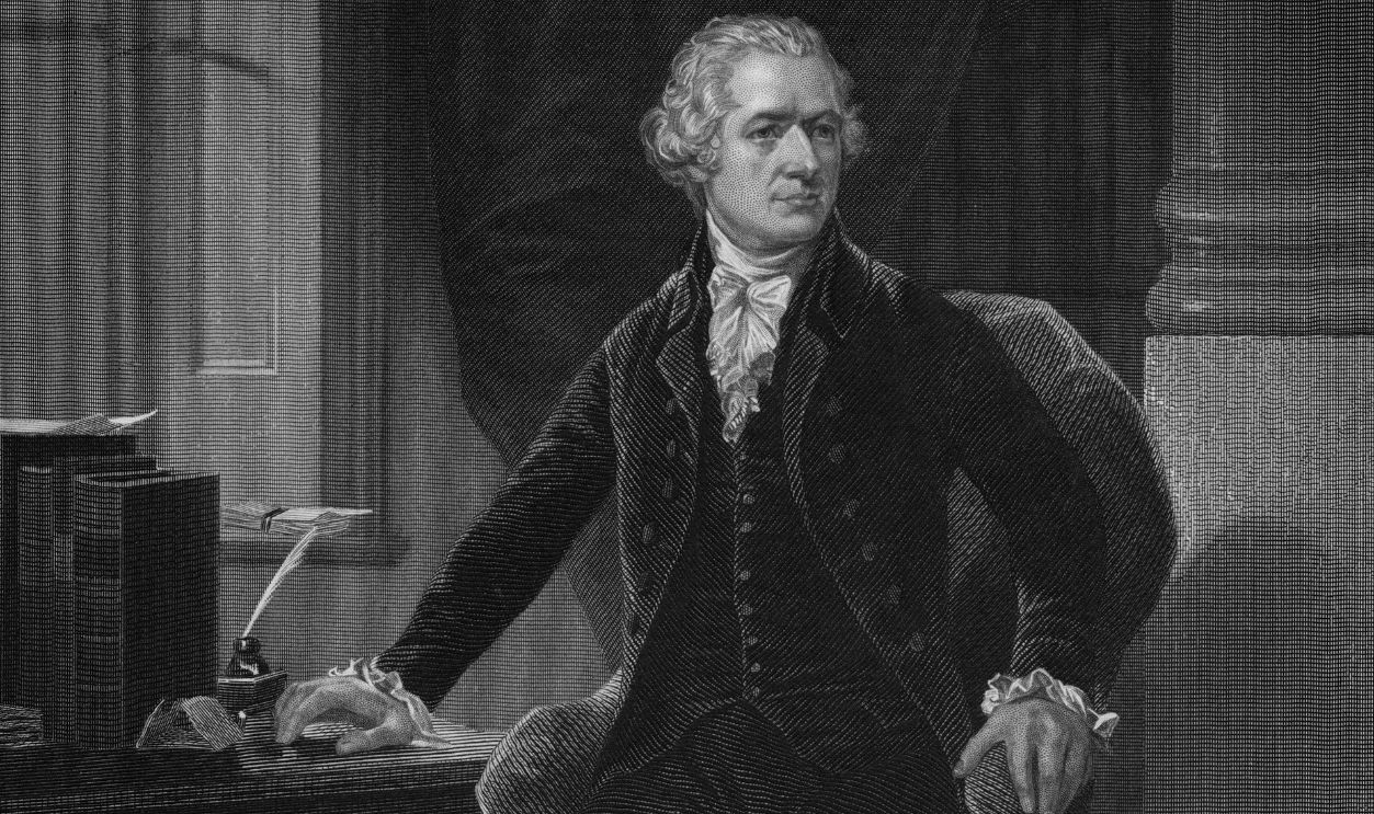 An etching from a full length portrait of Alexander Hamilton, he is depicted with books, writing utensils and his sword nearby to represent his professional, political, and military service, 1862. From the New York Public Library.