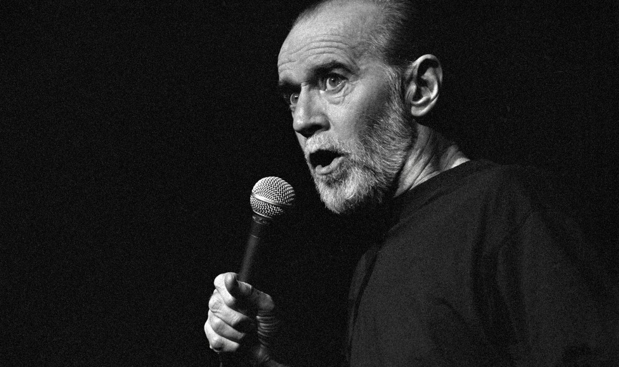 George Denis Patrick Carlin performs a standup routine at the Cheyenne Civic Center on June 1, 1992 in Cheyenne, Wyoming. Carlin was born in New York City in 1937 and went from class clown to standout American comedian. His shtick was described as counterculture and there is no doubt that American culture and politics were favorite targets of Carlin’s satire. In 2017 Rolling Stone magazine ranked him second behind Richard Pryor among the 50 best stand-up comedians of all-time. Following his death in 2008 at the age of 71, George Carlin was posthumously awarded the Mark Twain Prize for American Humor.
