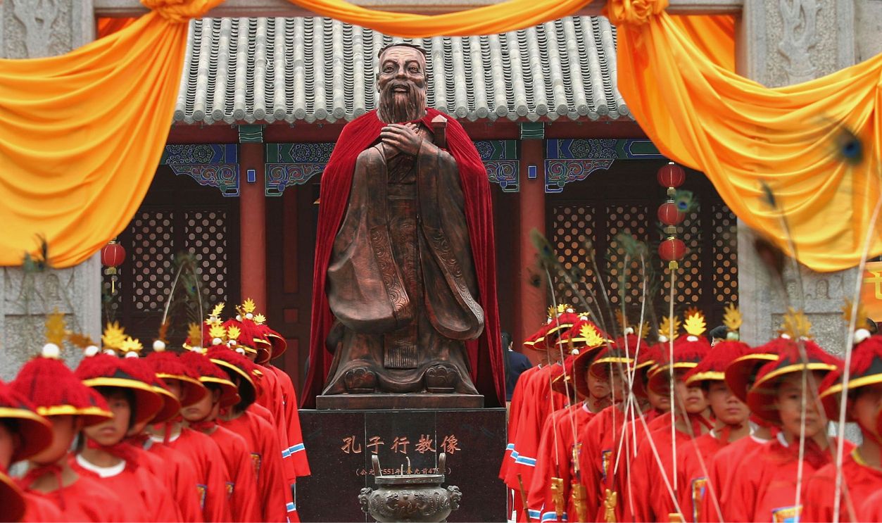 (CHINA OUT) Students dressed in ancient clothes stand in front of the statue of Confucius (551-479 BC), during a ceremony to worship the Chinese philosopher and educator at the Changchun Confucian Temple on September 25, 2005 in Changchun of Jilin Province, China. Various of ceremonies and celebrations are being held in China to mark the upcoming 2,556th anniversary of Confucius's birthday on September 28. During the day, the 