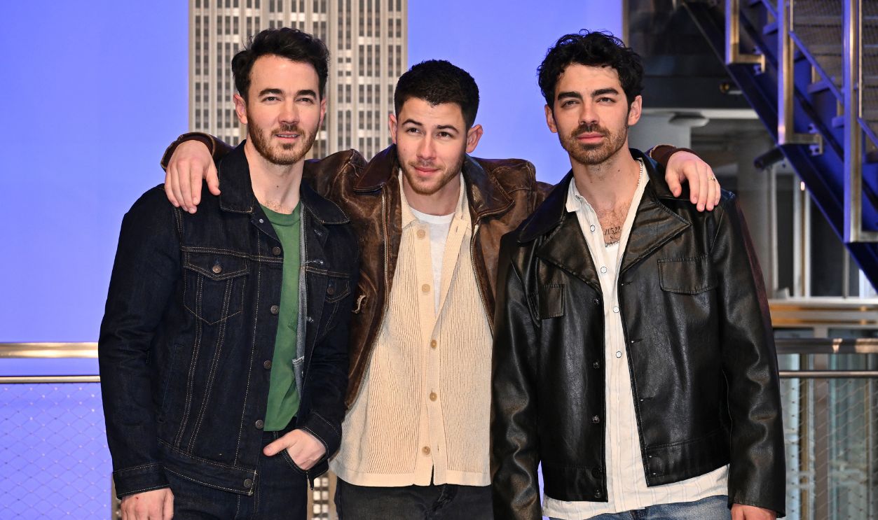 (L-R) The Jonas brothers Kevin Jonas, Nick Jonas, and Joe Jonas, pose at the Empire State Building during iHeartMedia New York's Z100 celebration of the 20th anniversary of their band in New York on March 21, 2025. The Jonas Brothers (L-R) Kevin, Nick and Joe Jonas together with iHeartMedia New York's Z100 light up the Empire State Building to celebrate the band's 20th anniversary on March 21, 2025 in New York City.