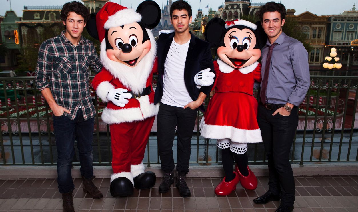 In this handout photo provided by Disney, The Jonas Brothers (L-R) Nick Jonas, Joe Jonas and Kevin Jonas pose with Mickey and Minnie Mouse while taking a break from taping the
