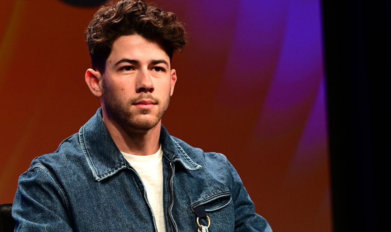 Nick Jonas speaks onstage at
