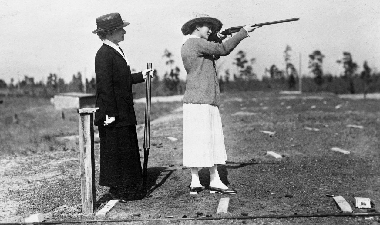 Mrs. W. Gould Brokaw shoots at flying targets. At the left is Annie Oakley.