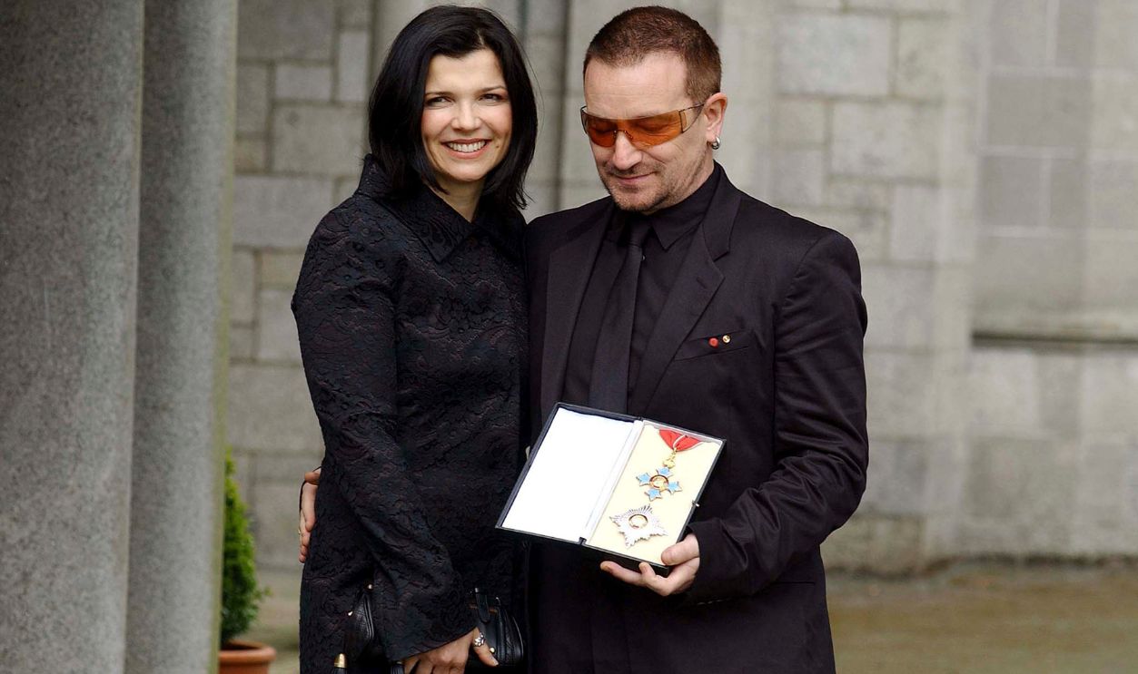  Bono, birth name Paul Hewson, poses with his wife Ali Hewson after receiving a Knighthood from Ambassador David Reddaway awarded to him by Her Majesty the Queen in recognition of his services to the music industry and his humanitarian work, at the British Ambassador's residence on March 29, 2007 in Dublin, Ireland. 