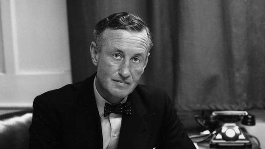 24th March 1958: Ian Fleming, British author and creator of James Bond, at his desk in his study.
