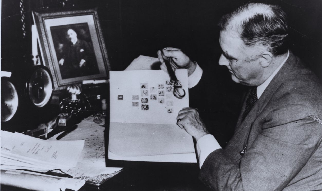 Gettyimages - 615296246, Franklin Roosevelt Examining His Stamp Collection Franklin Roosevelt, President of the United States from 1933-1945, was an avid stamp collector. Here he is shown perusing some of his collection.