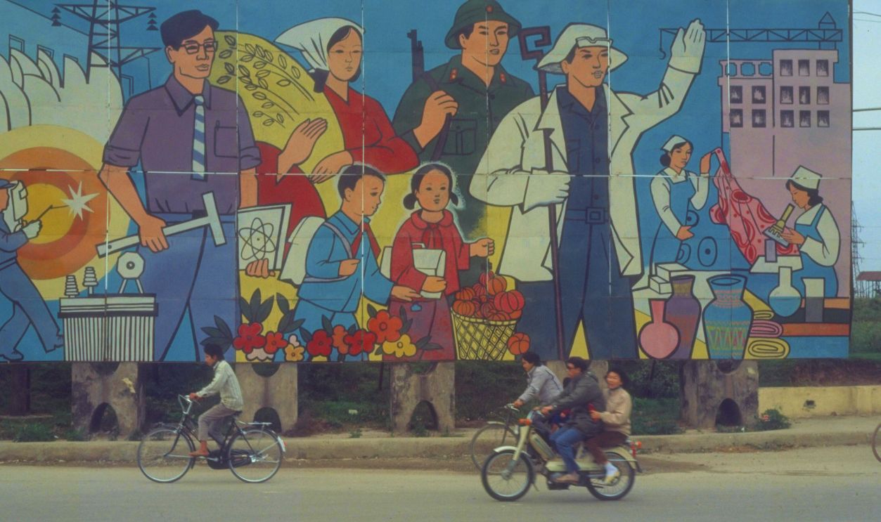 Gettyimages - 50580951, Pedestrians & bicyclists passing patriot Pedestrians & bicyclists passing patriotic billboards adorning streets of Hanoi, Vietnam. 