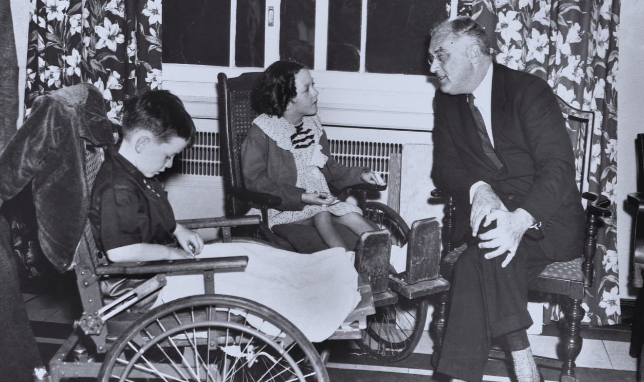 Gettyimages - 514080596, Roosevelt Talking to Disabled Children President Roosevelt talks to Renee Daly from Spring Valley, New York and Jerry Gould from Scranton, Pennsylvania. Roosevelt was the guest of honor at a luncheon given at the Warm Springs Foundation.