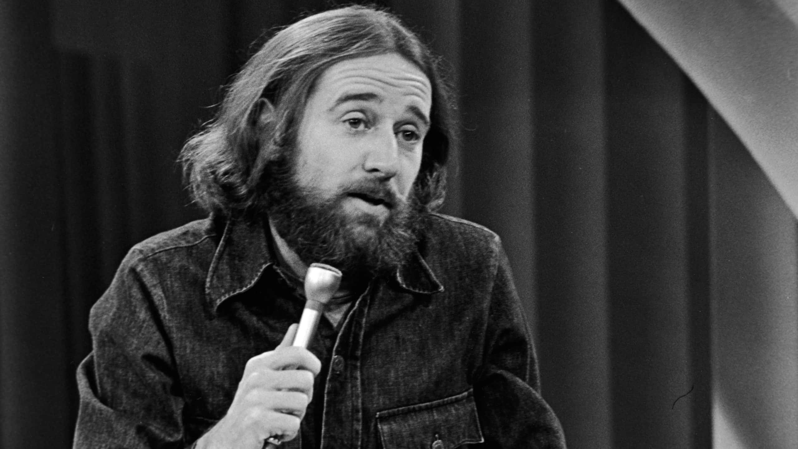 George Carlin Performing On StageAmerican comedian George Carlin performs his stand-up comedy act on stage, 1981.