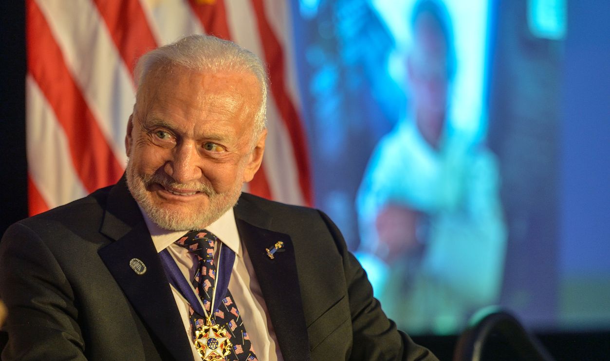 Buzz Aldrin smiles as he is interviewed by Hugh Hewitt, president of The Richard Nixon Foundation, during dinner commemorating the 50th anniversary of Apollo 11