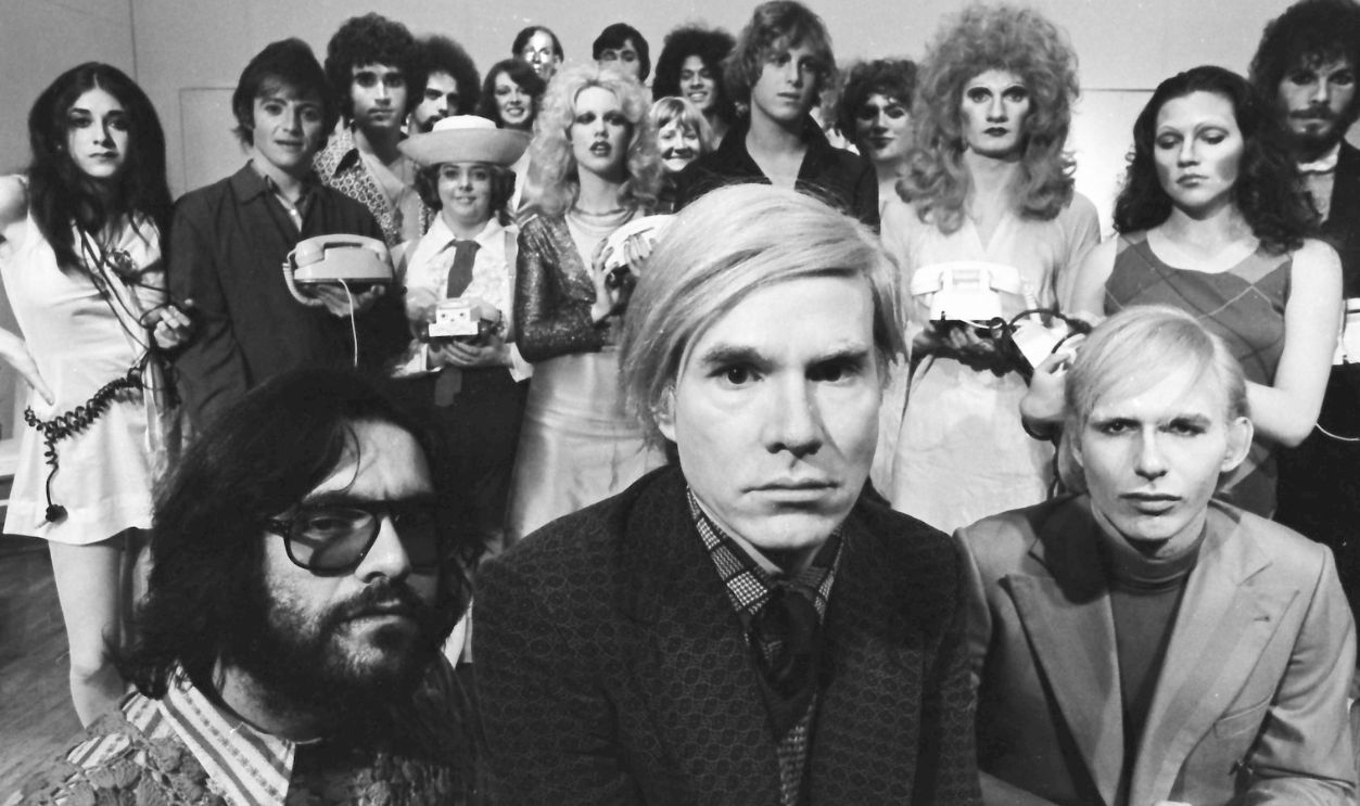 Andy Warhol with the cast of 'Pork' on stage at La Mama Experimental Theatre Club. Jayne (aka Wayne) County, Cleve Roller and Anthony Zanetta were featured players.