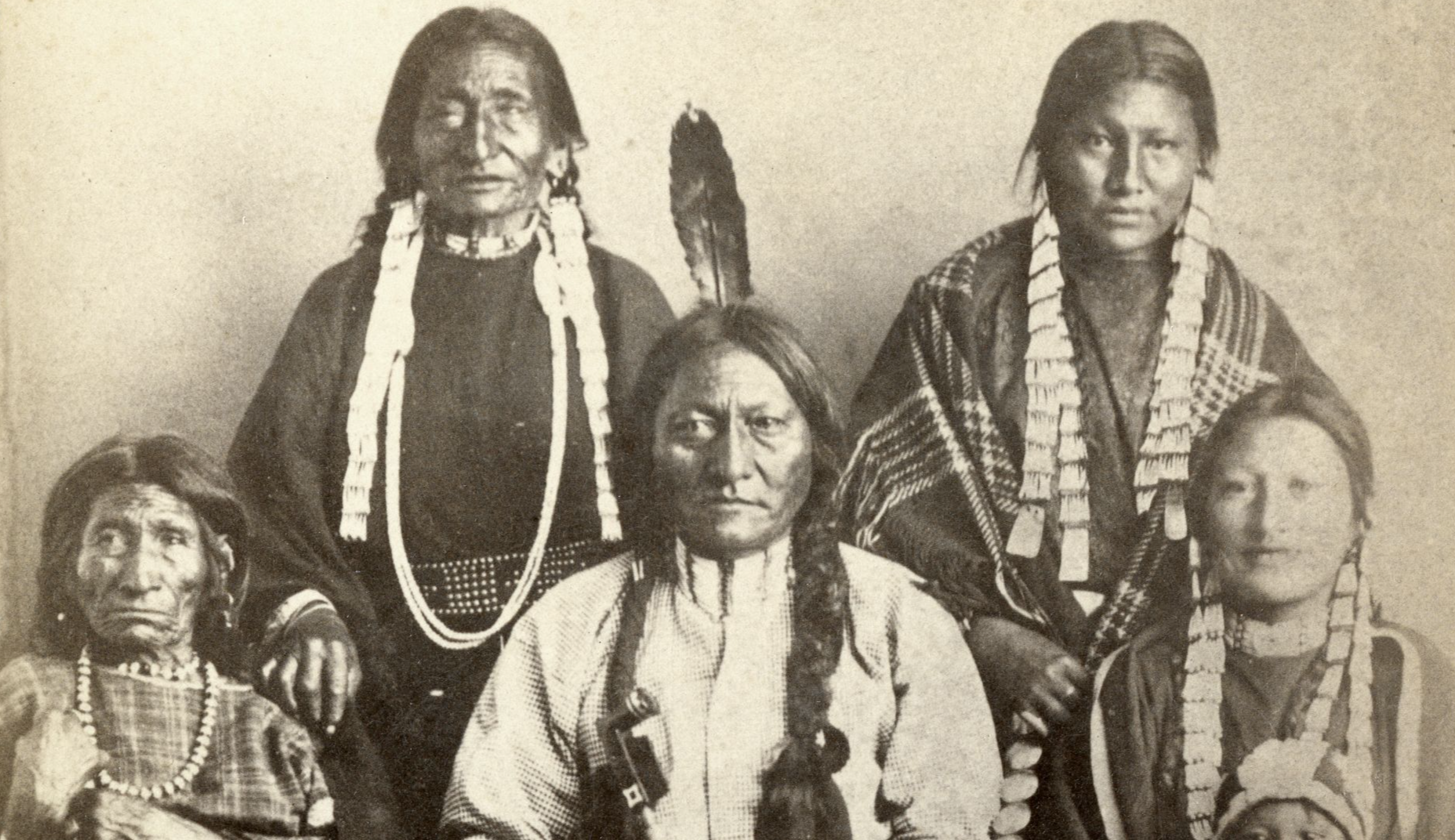 File:Sitting Bull and family 1881 at Ft Randall rear L-R Good Feather Woman (sister), Walks Looking (daughter) front L-R Her Holy Door (mother), Sitting Bull, Many Horses (daughter) with her son, Courting a Woman.jpg
