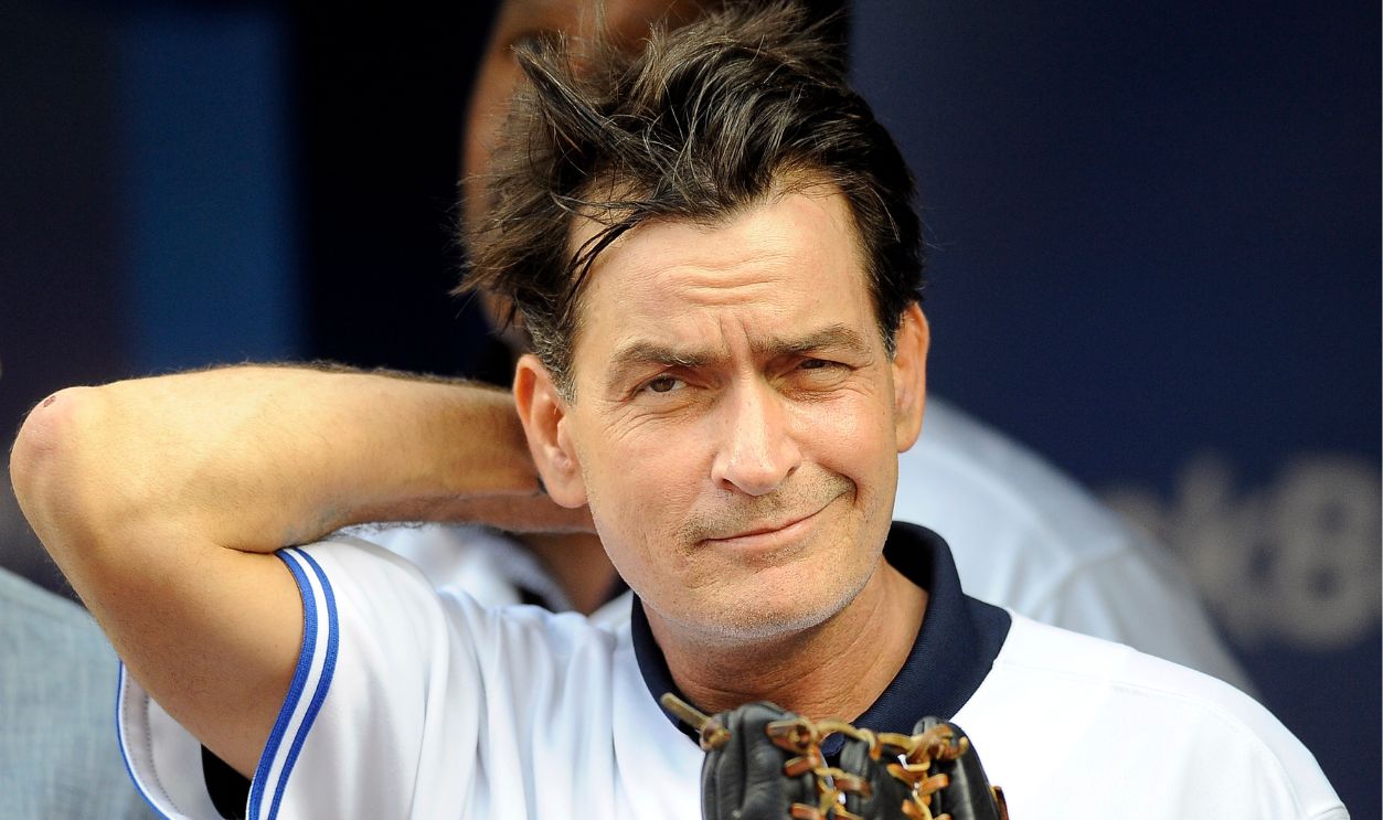 Actor Charlie Sheen throws out the ceremonial first pitch prior to MLB game action between the Toronto Blue Jays and Chicago White Sox August 14, 2012 at Rogers Centre in Toronto, Ontario, Canada.