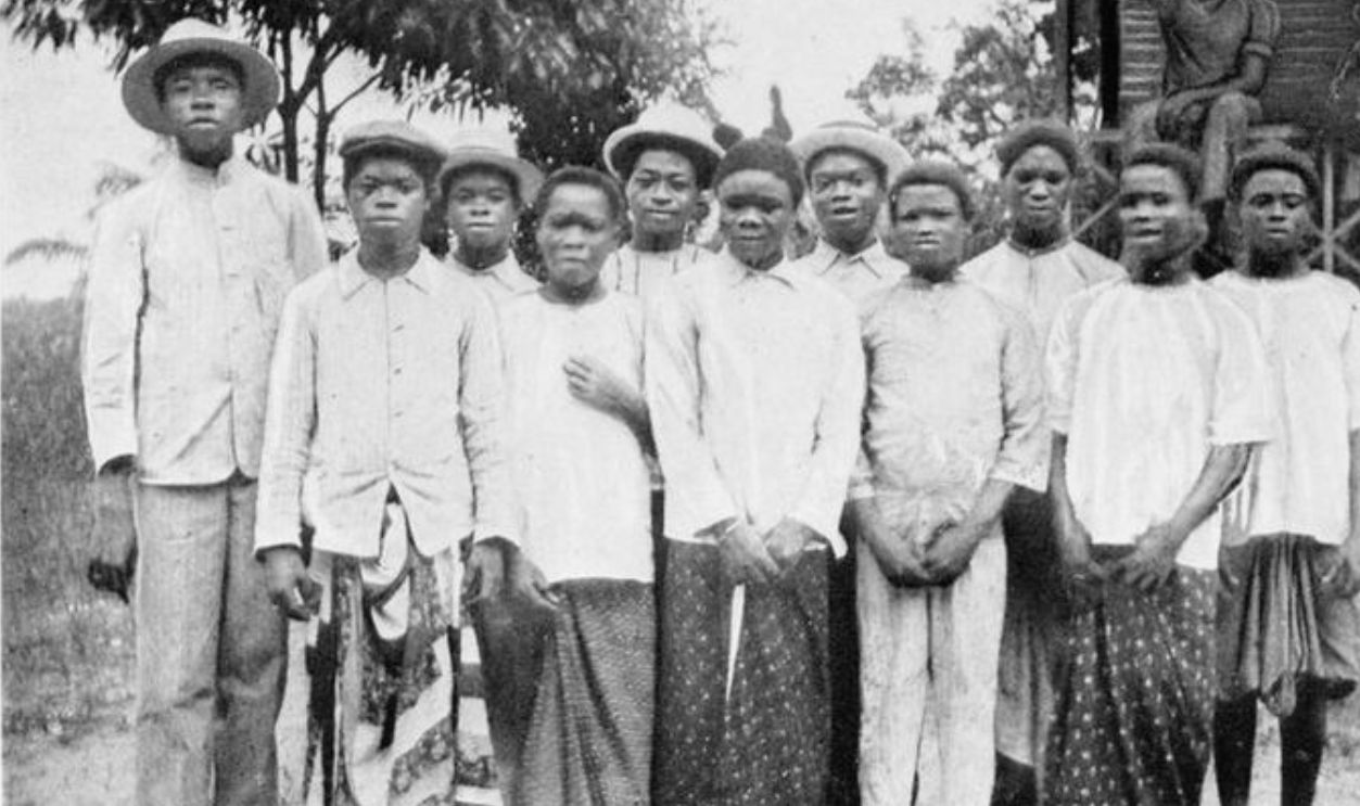 Fang Christians. In the middle of the front row stands Amvama. Behind him, on his right, is Ndong Koni. The tall young man is Robert Boardmen, the blind catechist. 