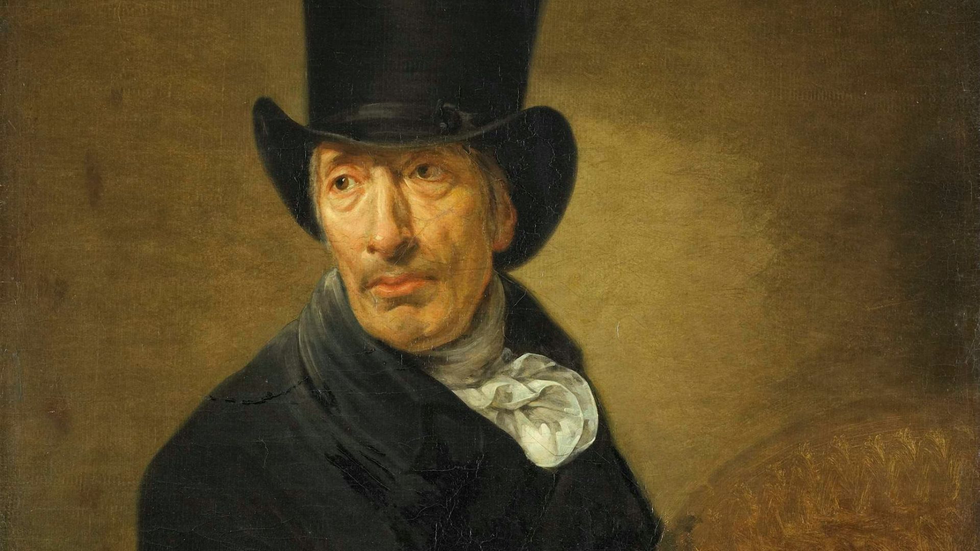 man in black cowboy hat holding brown animal