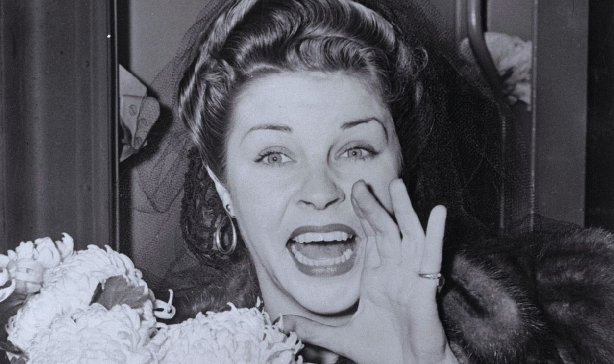 Gettyimages - 642055766, Portrait of Martha Raye (Original Caption) Martha Raye, stage and screen star, shown above greeting fans at Penn station, when she arrived November 18, will be made an honorary US Army pilot in ceremonies at a luncheon at Mitchel Field, LI, November 18.
