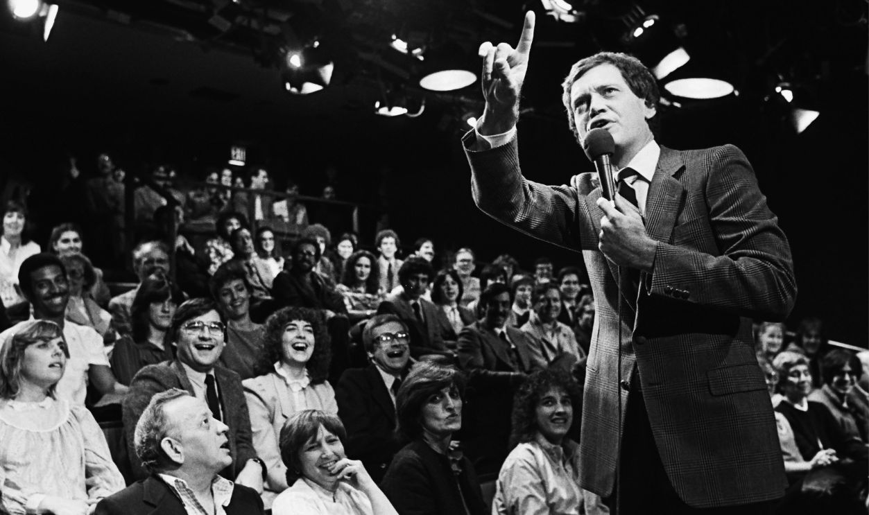 : Comedian and late night television host, David Letterman, warms up his NBC studio audience prior to the taping of his popular 1982 New York, NY, television show at Rockefeller Center. 