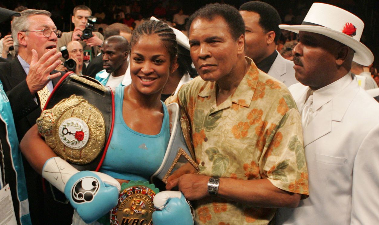 Laila Ali poses with her father, Muhammad Ali, after her 10 round WBC/WIBA Super Middleweight title bout with Erin Toughill at the MCI Center in Washington, DC. Ali won the fight via 3rd round TKO.